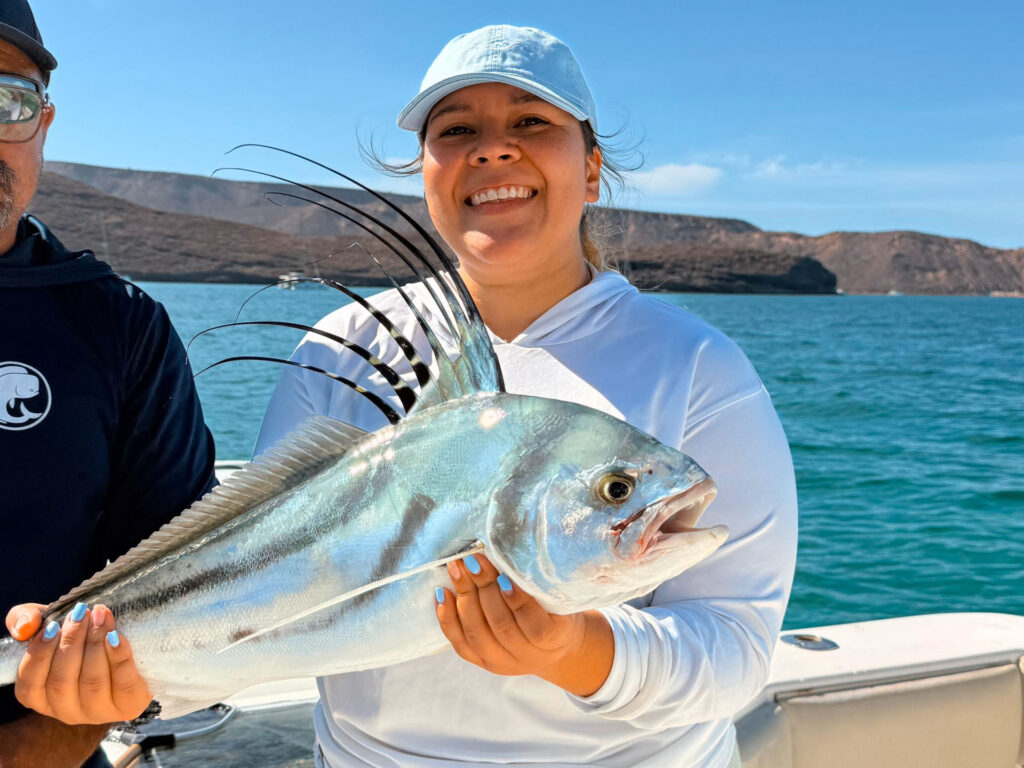 Angler holding a roosterfish during a La Paz fishing trip in Baja California Sur