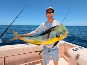 Angler holding a large dorado during an early season fishing trip in La Paz