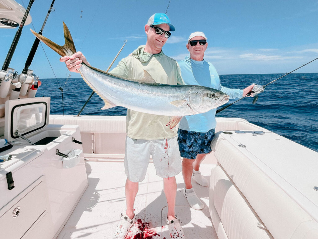 Two Anglers with a Yellowtail Offshore